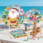 cocomigo Christmas in July party set with "Baby It's Warm Outside" banner, plates, cups, and tropical decorations.
