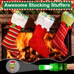 A hand wearing multiple colorful LED Christmas finger lights projecting festive images like Santa and snowmen in the dark.
