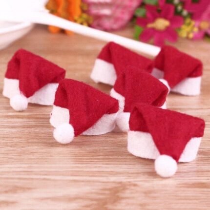 A close-up view of 30 small red and white Santa Claus hats, designed for decorating lollipops or small candies.