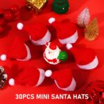 A close-up view of 30 small red and white Santa Claus hats, designed for decorating lollipops or small candies.