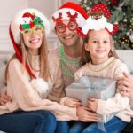 A collection of 24 red Christmas-themed party accessories including hats, headbands, and novelty glasses with cartoon pattern