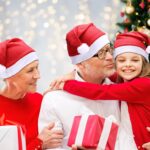 A large pile of 28 red and white plush Santa hats for adults, ready for a Christmas party.