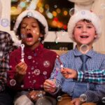 A bulk display of 40 mini bubble wands, each featuring different Christmas-themed designs like Santa, reindeer, and snowmen,