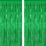 Two shimmering green metallic foil fringe curtains hanging, ready for a party backdrop or festive decoration.