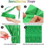 Two shimmering green metallic foil fringe curtains hanging, ready for a party backdrop or festive decoration.